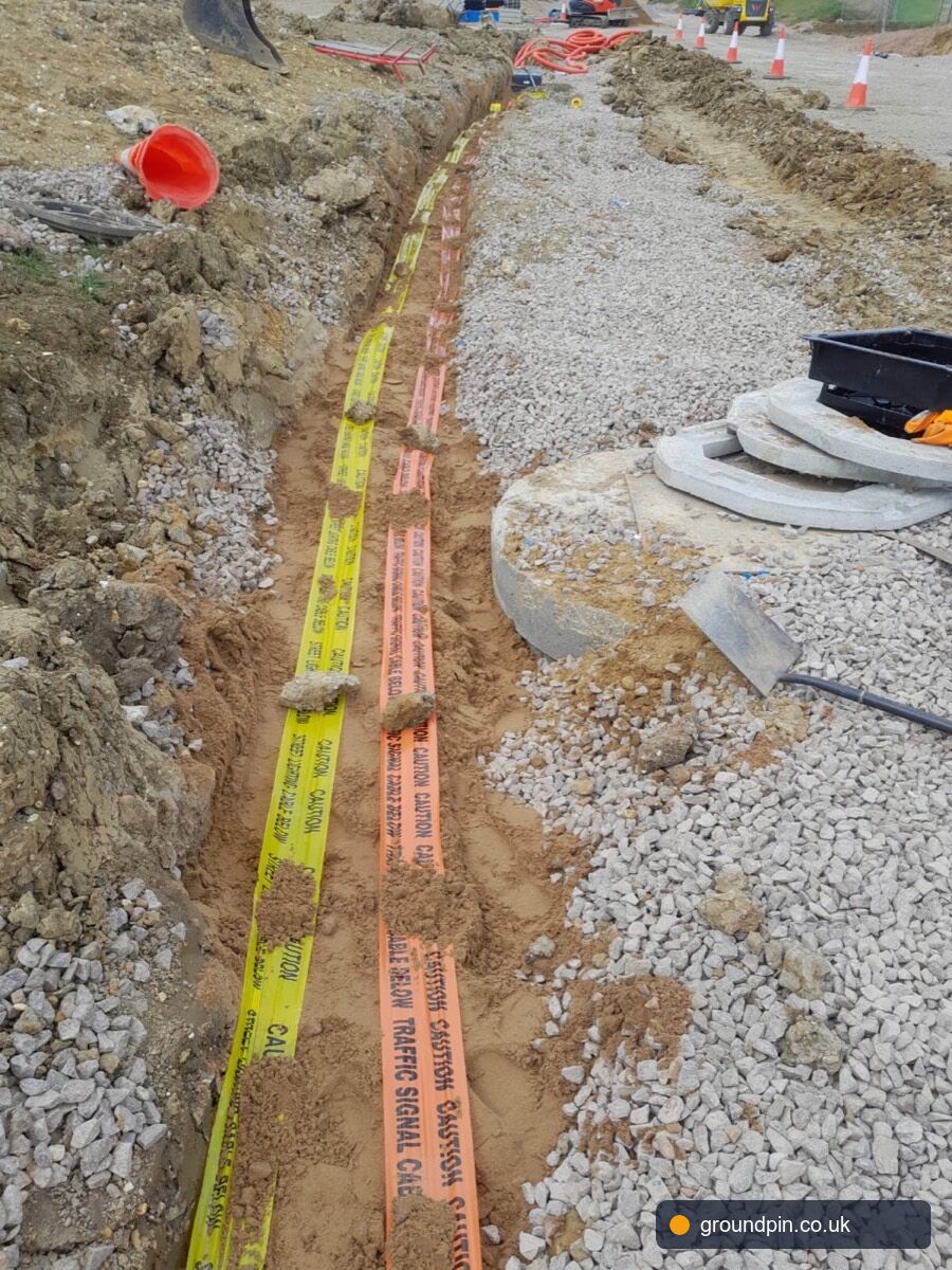 HSG47 warning tape over a duct stack in an open trench